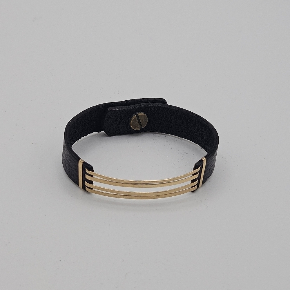 gold tone metal and black leather bracelet